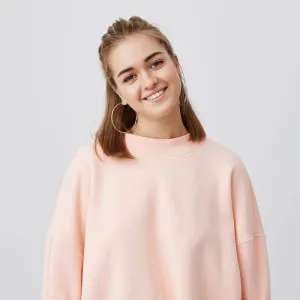 Close up shot of charming caucasian female with fair straight hair dressed in pink, gently looking , smiling while listening to interesting stories and good news. tender, beautiful, young. 